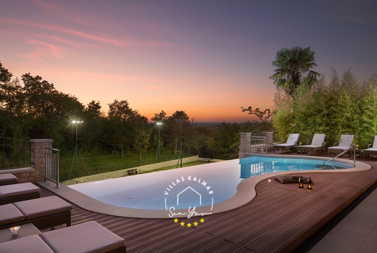 Evening view of the heated pool at Villa Vlastelini I in Labin-Rabac