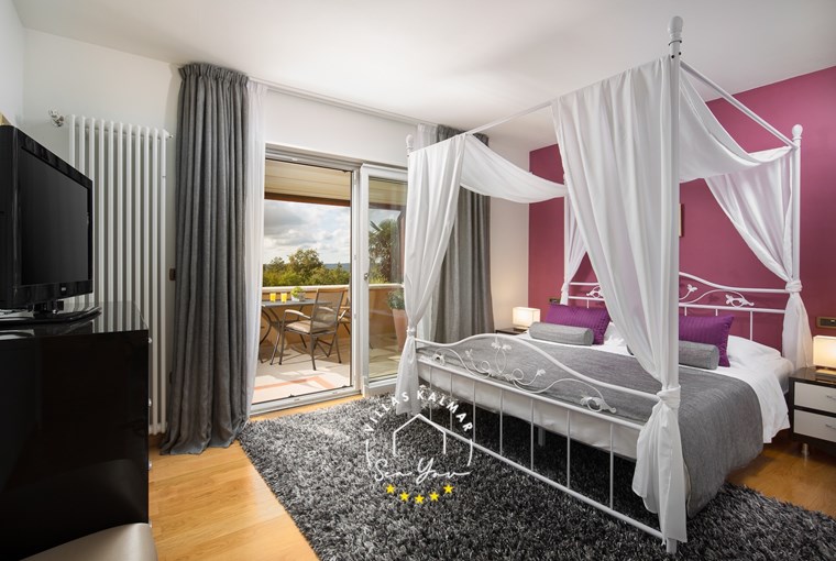 Elegant bedroom with natural materials at Villa Vlastelini I in Labin-Rabac