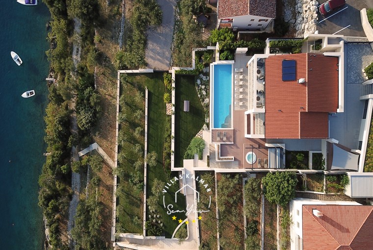 Aerial view of Villa Vlastelini II above the turquoise bay of Duga Luka