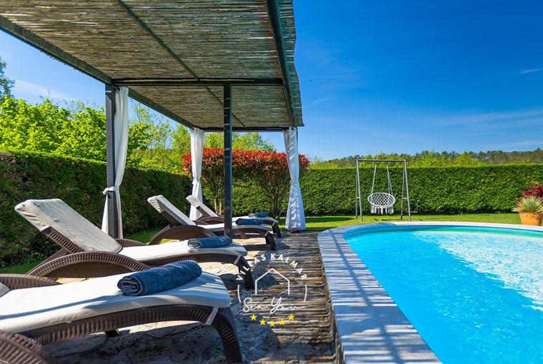 Sun loungers next to private pool of villa