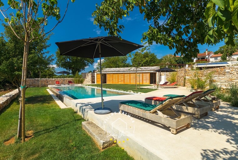Sunbeds by the pool in villa in Motovun
