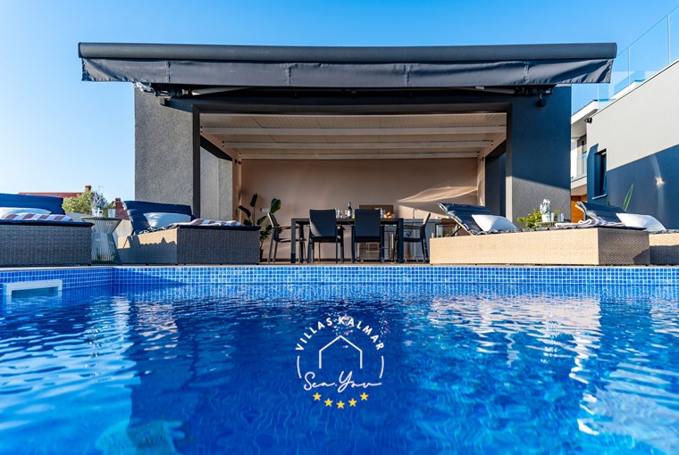 Private pool, sun loungers and outdoor dining area in Istria