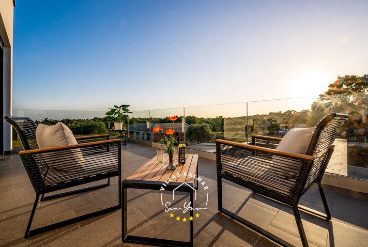 Balcony of villa with sunny view of nature
