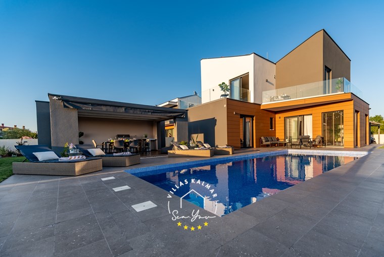 Luxurious villa with private pool, sun loungers and outdoor dining area