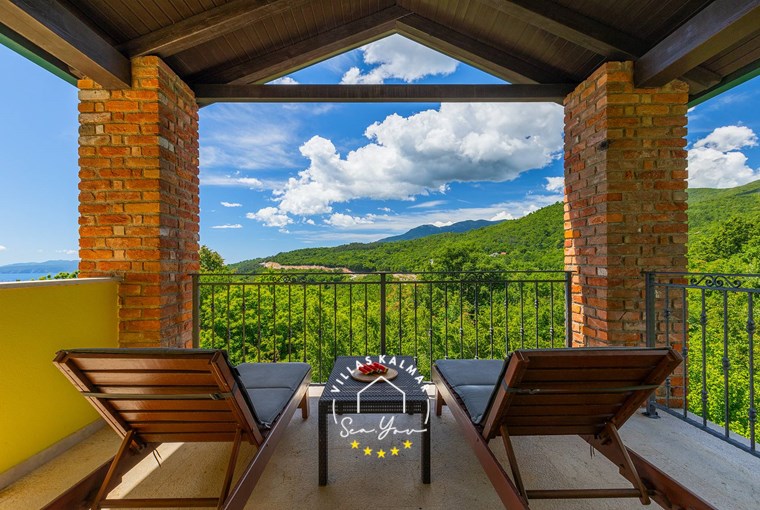 Sun loungers on the terrace with a stunning view over the green surroundings in Villa Angeli near Opatija