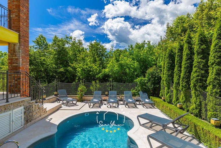 Comfortable sun loungers by the pool surrounded by nature - Villa Angeli near Opatija