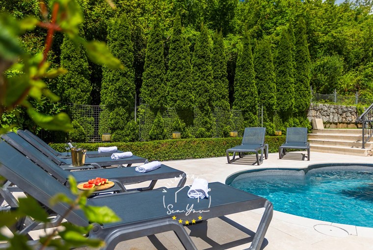 Comfortable sun loungers by the pool surrounded by nature - Villa Angeli near Opatija