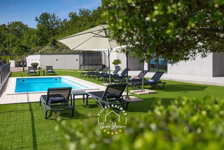 Beautiful outdoor area with private pool, sun loungers and parasols at luxury Villa Lavinia near Opatija