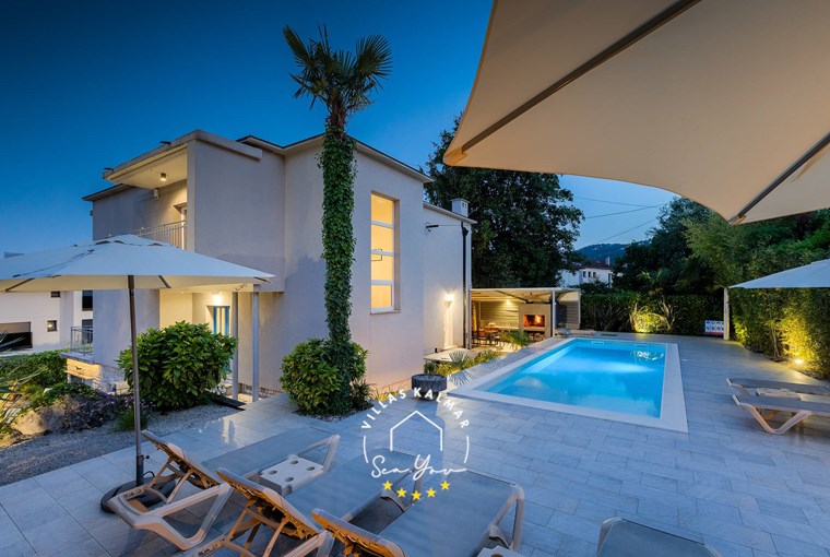 Beautiful Villa Lovran with outdoor private pool, parasols and sun loungers at night - near Opatija