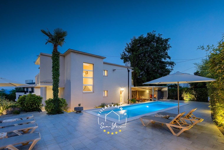 Beautiful Villa Lovran with outdoor private pool, parasols and sun loungers at night - near Opatija