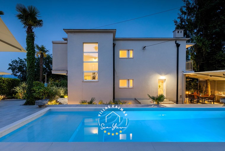 Family villa with outdoor private pool at night in Lovran