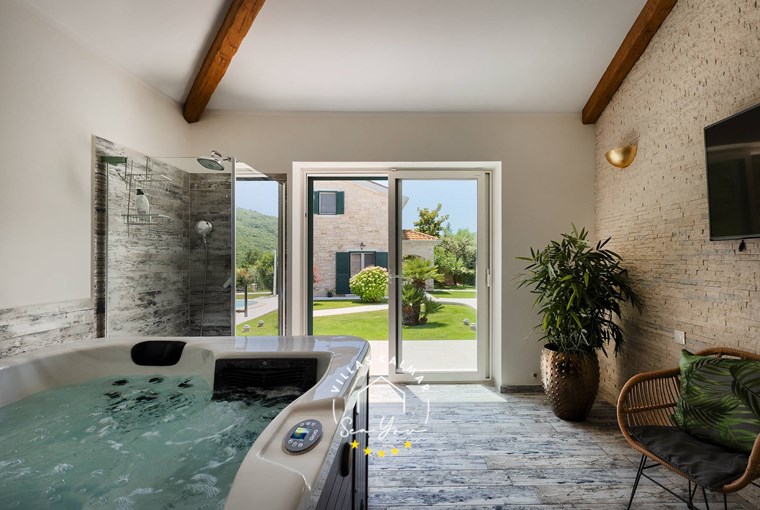 Wellness oasis with hot tub, TV and balcony doors leading out into the garden of beautiful authentic villa in The Kvarner Bay