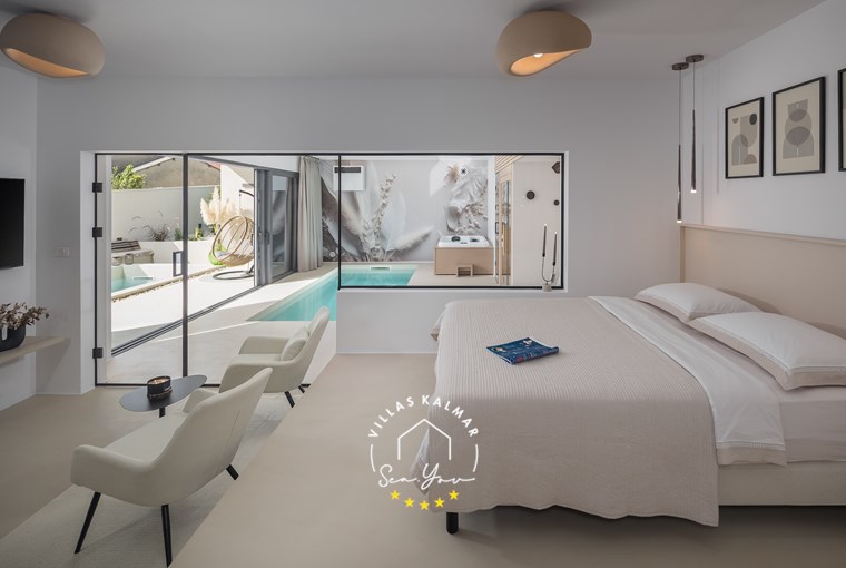 Elevated bed with pool view – romantic bedroom design at Villa Amoreta