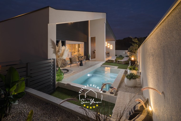 Romantic evening atmosphere with illuminated outdoor pool and terrace in our luxury villa in Labin-Rabac