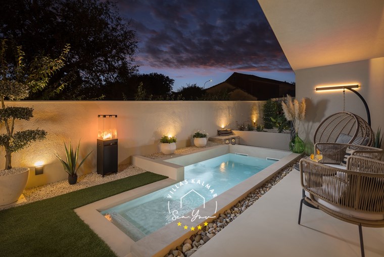 Romantic outdoor seating area with warm lighting at Villa Amoreta