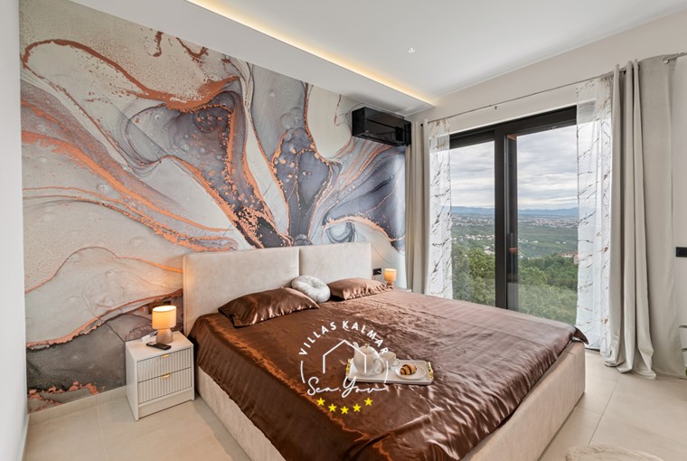 Double bedroom with balcony doors and view over the Kvarner Bay in Villa Gabi near Opatija