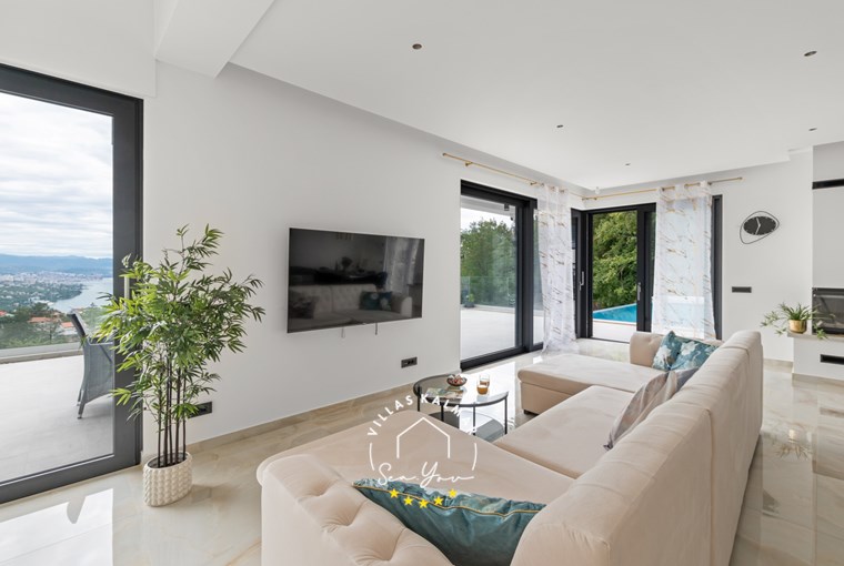 Modern living area with sofa, TV and balcony doors in Villa Gabi, Kvarner Bay