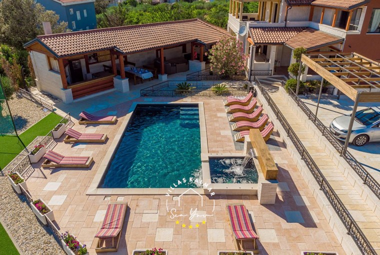 Outdoor area of Villa My Way with private pool, sun loungers and parking lot