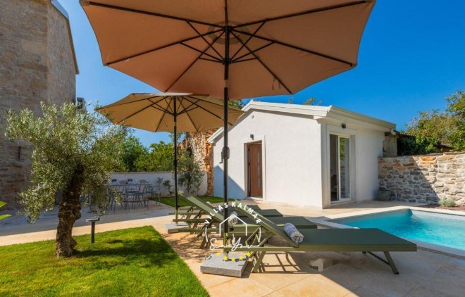 Outdoor area with private pool, sun loungers, parasols and wellness house in Villa Andrea in Central Istria