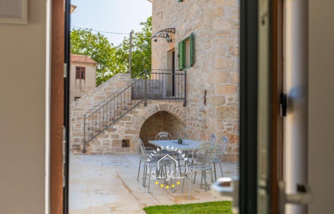 View over the entrance and outdoor dining area in renovated stone villa in Central Istria