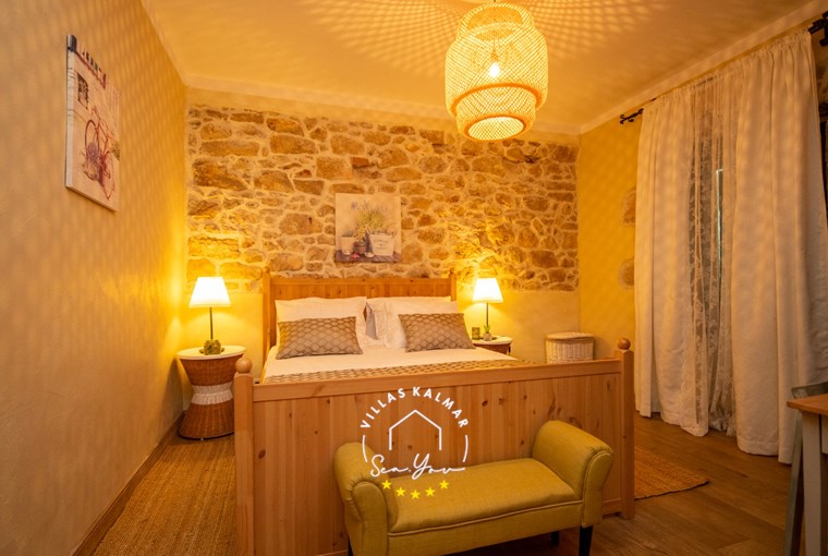 Cozy bedroom with accent stone wall in Villa Bozini Dvori, near Zadar