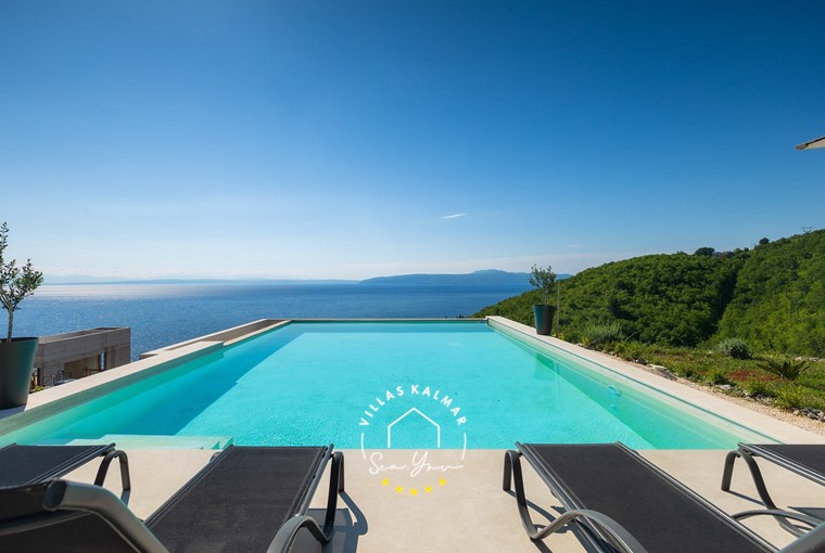 Private pool of villa with sun loungers and sea view in Labin